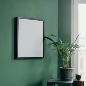 Stylish interior featuring a blank frame on a green wall and a potted plant by a window.